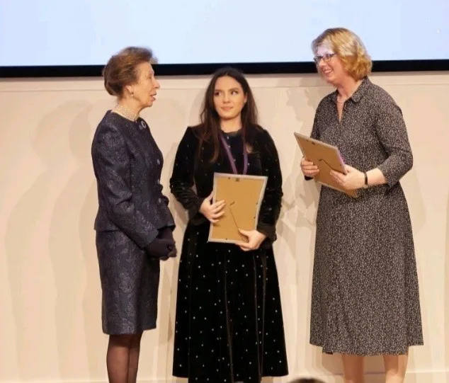 Flavia Popescu receiving an award at a presentation ceremony